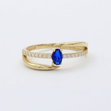 Anillo de Oro 14k Diseño Cruzado con Zirconia Azul Oval y Carril de Zirconias mod. 10390